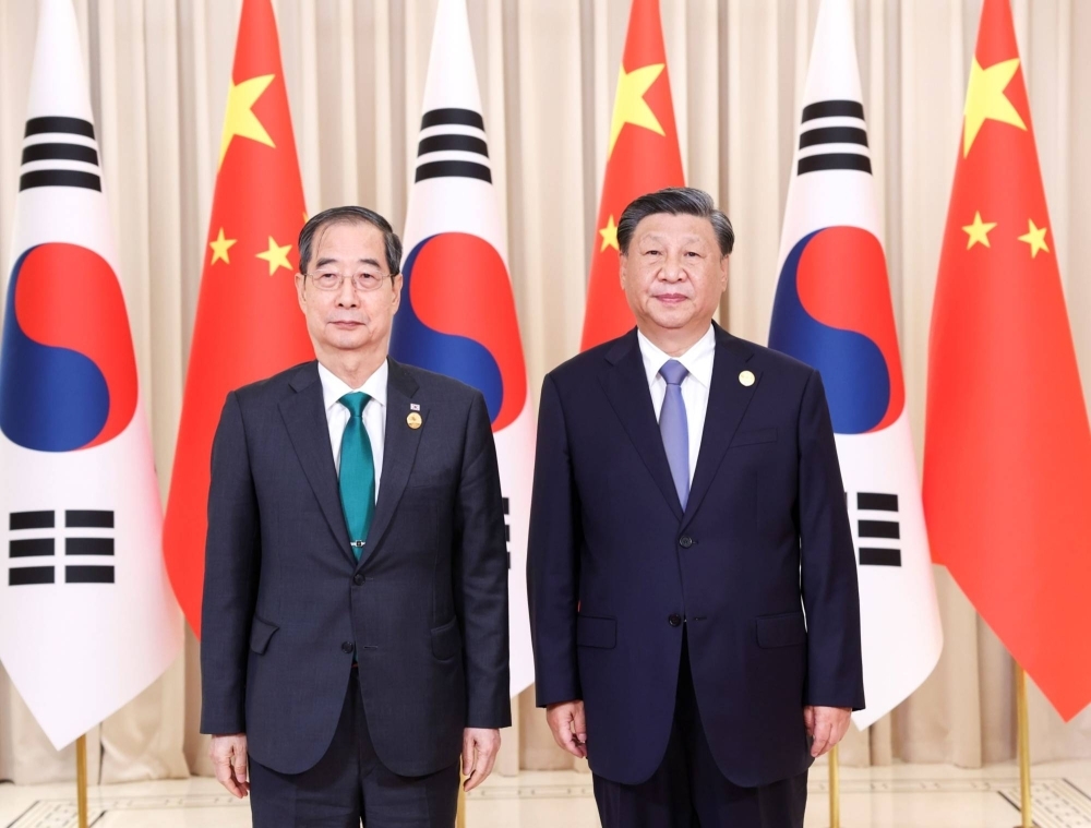 Xi Jinping Primo Ministro della Corea del Sud Han Duck-soo all'incontro avvenuto ai Giochi Asiatici